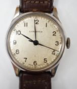 A gentleman's mid 20th century stainless steel Longines manual wind wrist watch, on associated