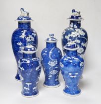 Five early 20th century Chinese blue and white prunus vases and covers, tallest 31cm