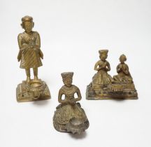 Three Nepalese figural brass oil lamps, 18th/19th century Provenance: acquired on travels to India
