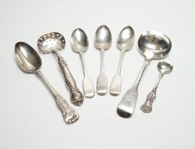 A William IV silver fiddle pattern sauce ladle, London, 1831 and six other assorted silver spoons.