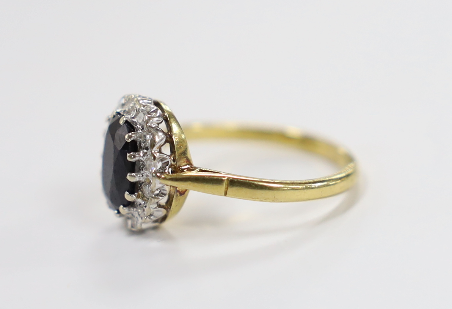 A modern 18ct gold, sapphire and diamond set oval cluster ring, size Q, gross weight 4.9 grams. - Image 2 of 3