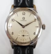 A gentleman's late 1950's stainless steel Omega manual wind wrist watch, with subsidiary seconds, on