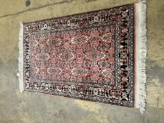 A North West Persian peach ground rug,120 x 76cm