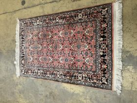 A North West Persian peach ground rug,120 x 76cm