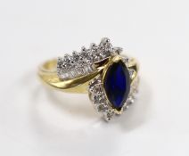 A modern 14kt, sapphire and diamond set crossover cluster ring, size M, gross weight 5.5 grams.