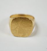 A 750 yellow metal signet ring, size N, 8.9 grams.