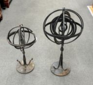 Two wrought iron armillary spheres, largest 65cm