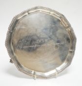 A George V silver waiter, of shaped circular form, on three claw and ball feet, Fordham & Fordham,