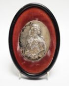 A small framed white metal oval plaque, modelled as a bust of Lord Nelson in relief, 86mm by 67mm.