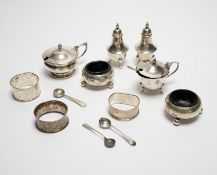 Six assorted silver cruets and three silver napkin rings.