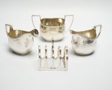 A George III engraved silver cream jug, London, 1808, height 82m, a George V silver cream jug and