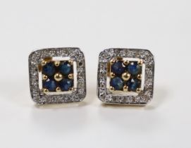 A modern pair of 375 yellow metal, sapphire and diamond chip set square cluster earrings, one