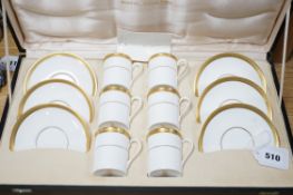 A cased Royal Doulton Royal gold pattern set of coffee cans and saucers