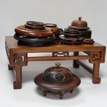Nine Chinese hardwood vase stands, two hardwood covers and a Chinese hongmu table shaped stand,