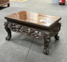 A Chinese low rectangular hardwood stand carved with dragons, width 39cm, depth 25cm, height 21cm