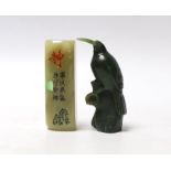 * * A carved spinach green jade model of a bird and a Chinese soapstone scroll weight, largest 7cm