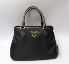 A Prada bag, with authenticity cards and dust bag