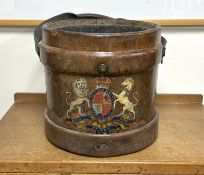 A Victorian tan leather shot carrier with applied royal crest and tin liner, diameter 35cm, height