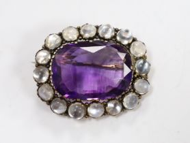 A yellow metal, amethyst and moonstone cluster set oval brooch, 34mm, gross weight 10.4 grams.