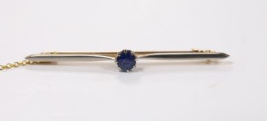 An early 20th century yellow metal and single stone sapphire set bar brooch, 57mm, gross weight 4.