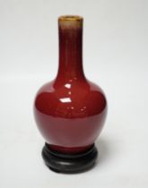 A small Chinese sang de boeuf glazed vase and stand 22cm high including stand
