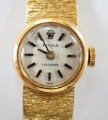 A lady's textured 750 yellow metal Rolex manual wind wrist watch, on integral bracelet, no box or