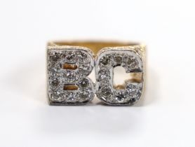 A textured 9ct and diamond cluster set 'BC' initials ring, size Q, gross weight 14.3 grams.