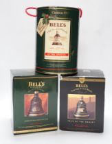 Five Christmas or New year Bell's whisky bottles, three in tins and one boxed