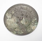 A Chinese cast bronze mirror, decorated with vines, and mythical creatures, diameter 12.5cm