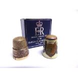 ROYAL MEMORABILIA - SEWING ACCESSORIES Two commemorative thimbles, comprising one sterling silver