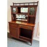 AN EDWARDIAN MAHOGANY DRESSER the mirrored upper section with bevel glazed doors, the base with