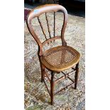 A VICTORIAN BEECH CORRECTIONAL CHAIR with caned seat, 92cm high Condition Report : good condition,