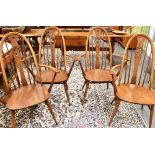 A SET OF FOUR ERCOL 'SWAN BACK' WINDSOR ARMCHAIRS Condition Report : solid, but tatty in places,