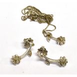 A STAMPED 750 AR WHITE GOLD AND DIAMOND DEMI PARURE Comprising a pendant flower drop earring and