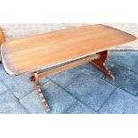 AN ERCOL REFECTORY DINING TABLE the rectangular top 88cm x 183cm, on shaped supports united by