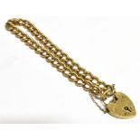 A 9CT GOLD HEART PADLOCK CURB LINK BRACELET and safety chain, chain width 6mm, weight 21g