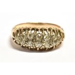 A VINTAGE DIAMOND BOAT RING The boat set with 12 small old cut diamonds in white metal on an