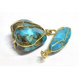 TWO MIDDLE EASTERN TURQUOISE MATRIX PENDANTS The two pendants held in fine yellow metal wire with