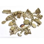 A SILVER AND WHITE METAL CHARM BRACELET Weight 67.4g