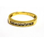 18CT GOLD CHANNEL SET DIAMOND SEVEN STONE RING The shank marked 18ct DiA.25