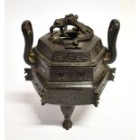 A CHINESE BRONZE TWO HANDLED KORO AND COVER of archaic hexagonal form, the pierced lid applied