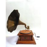 A REPRODUCTION TABLE-TOP GRAMOPHONE bearing H.M.V. branding, with a brass horn. Condition Report :