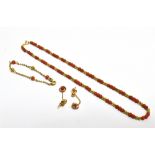 AN ARABIAN PARURE OF 18CT GOLD AND CORAL The necklace of ball design set with red coloured coral