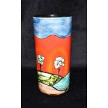 A POOLE POTTERY CYLINDRICAL VASE decorated with a landscape scene on a red ground, artists