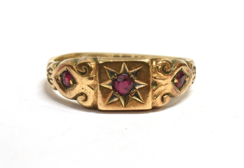 A VINTAGE 9CT GOLD RUBY GYPSY RING The ring set with three round cut rubies, the central ruby star