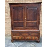 AN OAK PRESS CUPBOARD with pair of fielded panelled doors opening to hanging space, two drawers to