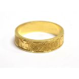 AN 18CT GOLD PATTERNED BAND RING The ring in engine turned pattern sections alternating with applied