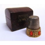 SEWING ACCESSORIES - A CORAL SET 800 SILVER THIMBLE in a fitted leather trunk-style case.