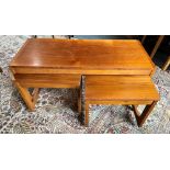 A NEST OF THREE TEAK TABLES on casters, the largest table 90cm x 38cm, 44cm high Condition