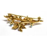 A 9CT GOLD, TURQUOISE SET FLORAL SPRAY BROOCH The brooch set with seven turquoise cabochons, the